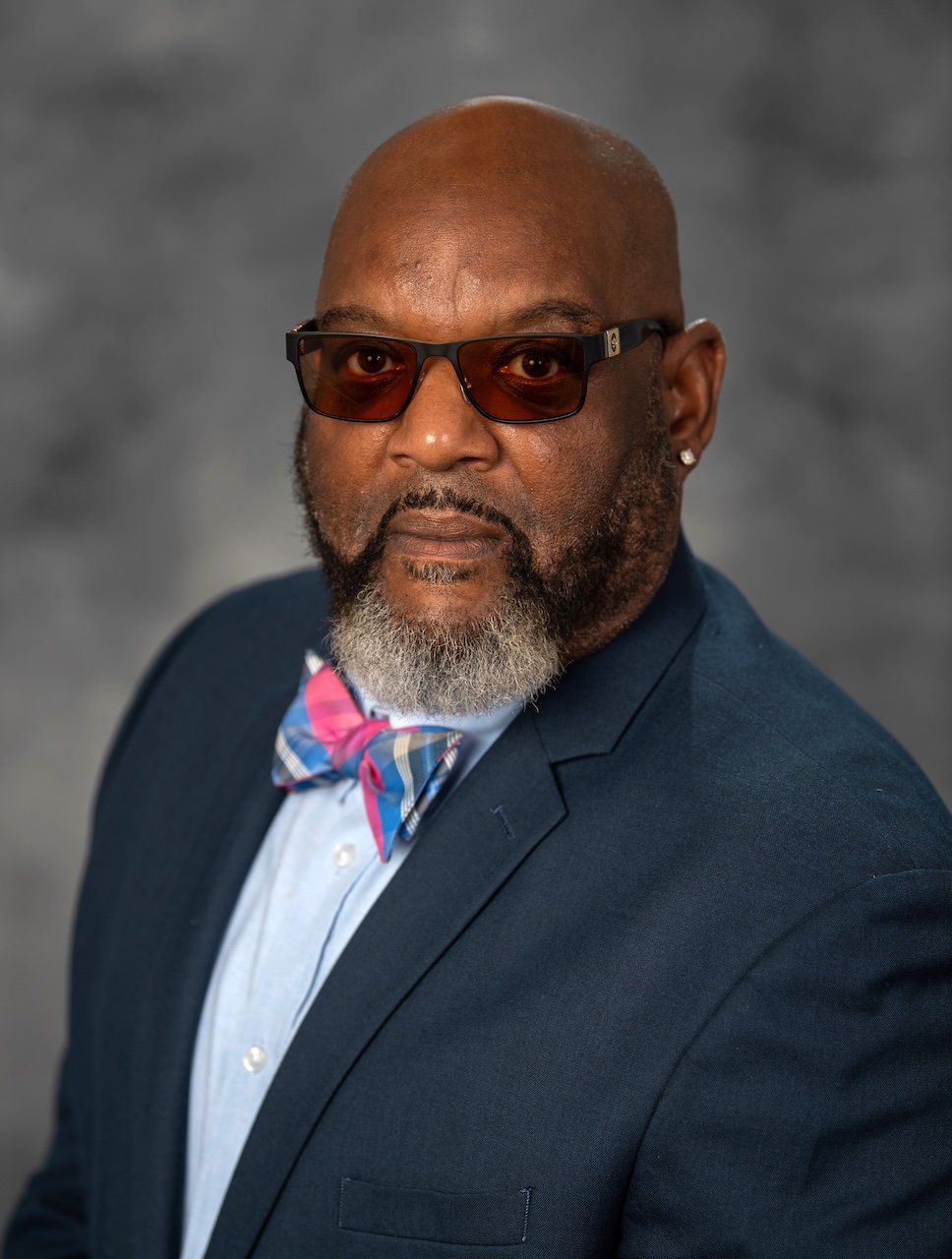 Mr. Purcell Braxton against a gray background. 
