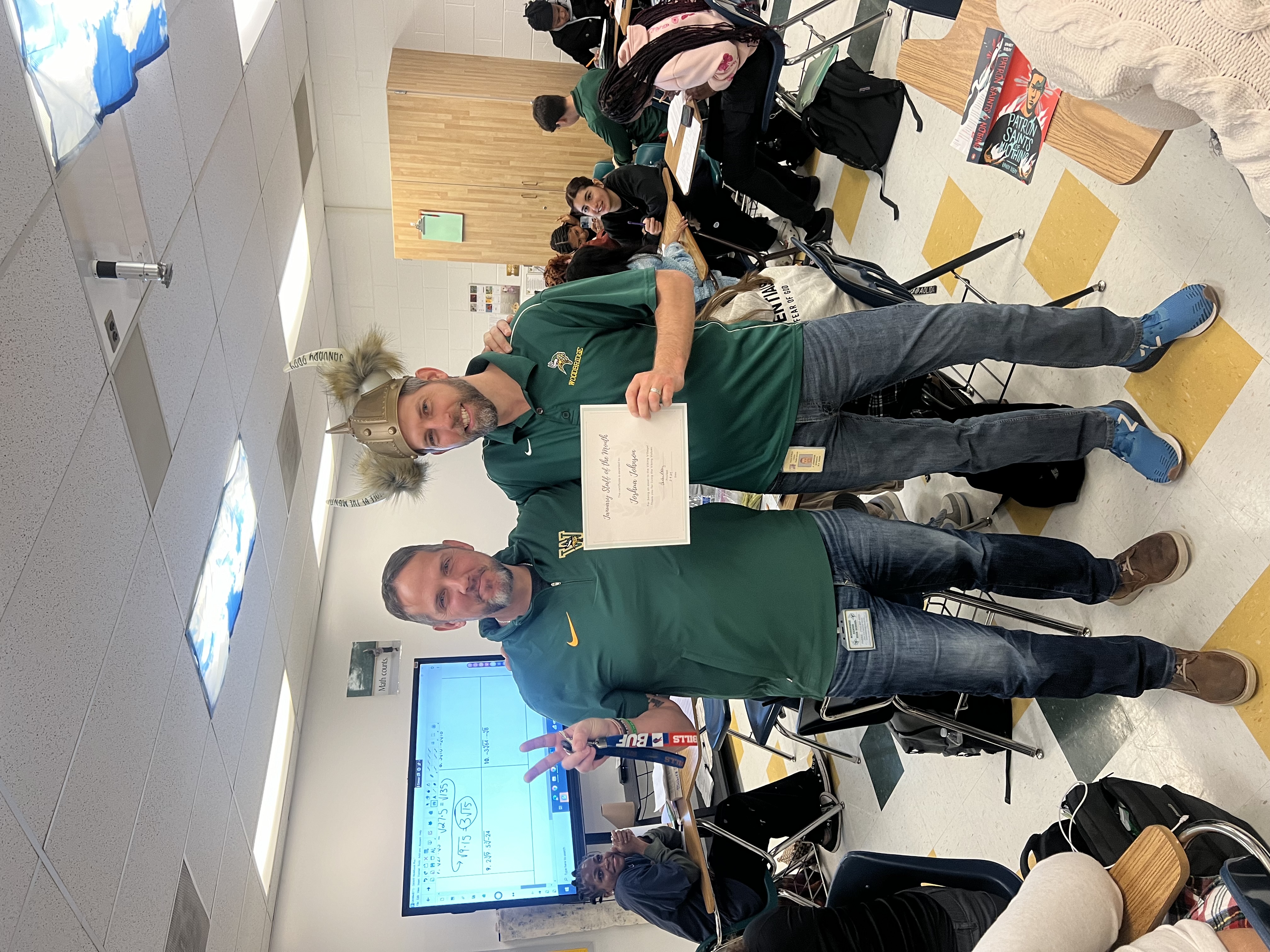 Mr. Johnson holding staff of the month award
