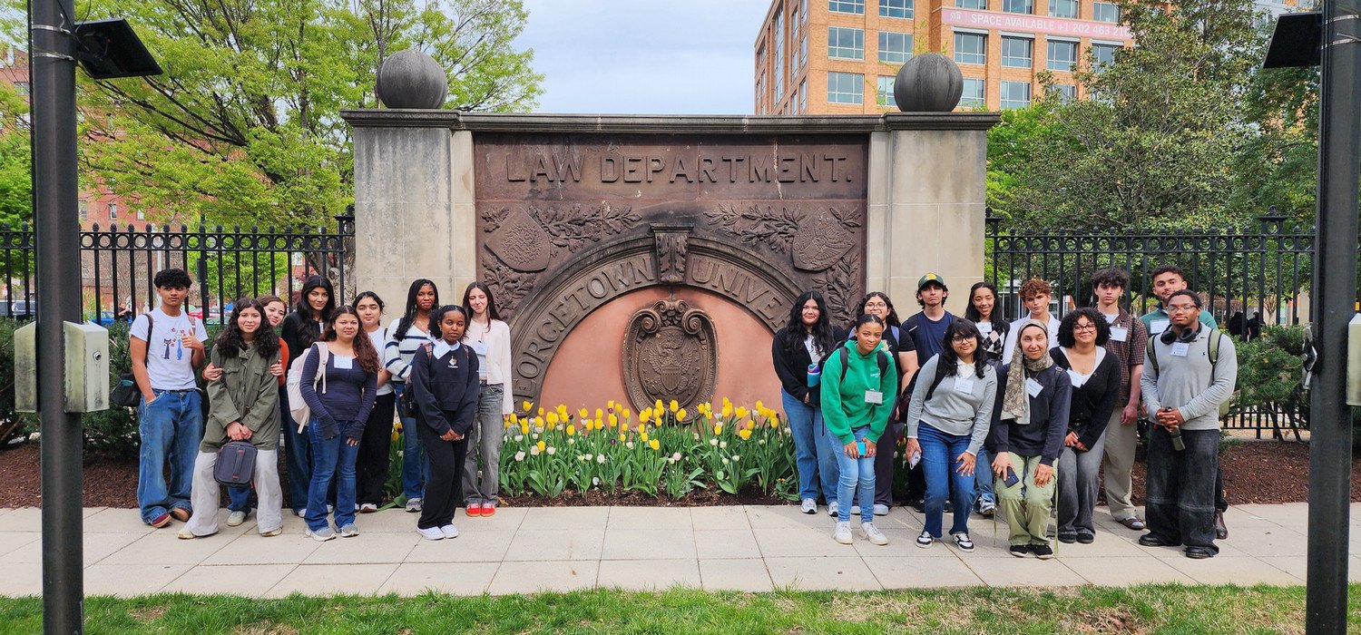 WSHS students in group photo taken in front of the Law Department monument at Georgetown University, featuring students and faculty members.