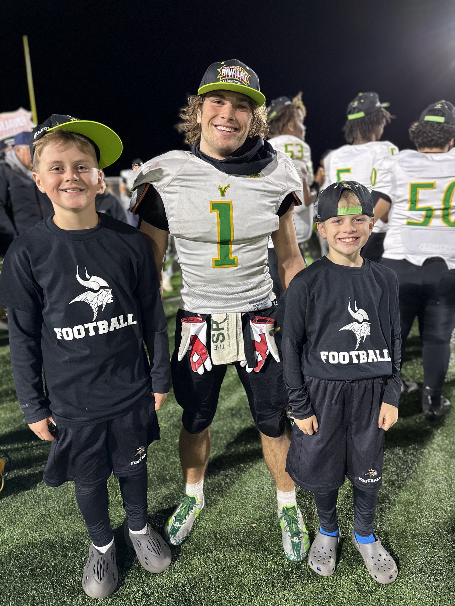 WSHS football ball boys Henry and Jack Millette with football player Mark Crunkilton at the District Championship game.