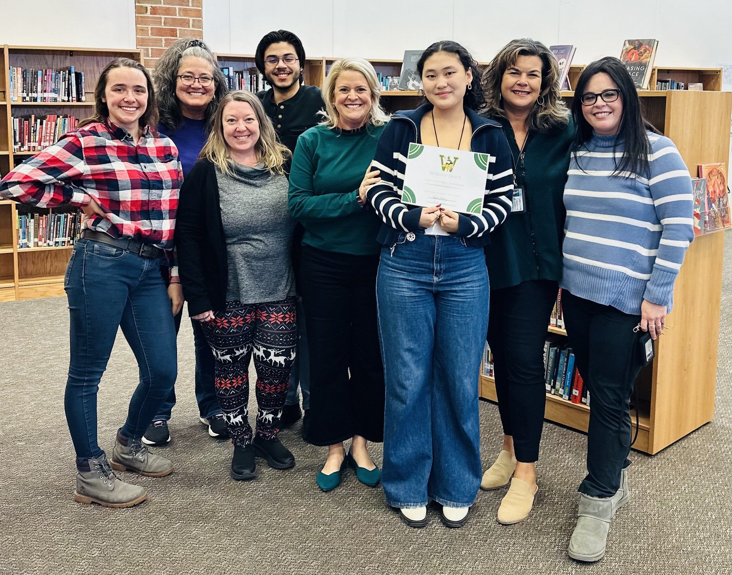 Grace receiving her BeMoore Award from Ms. Abney and being congratulated by WSHS teachers and librarians.