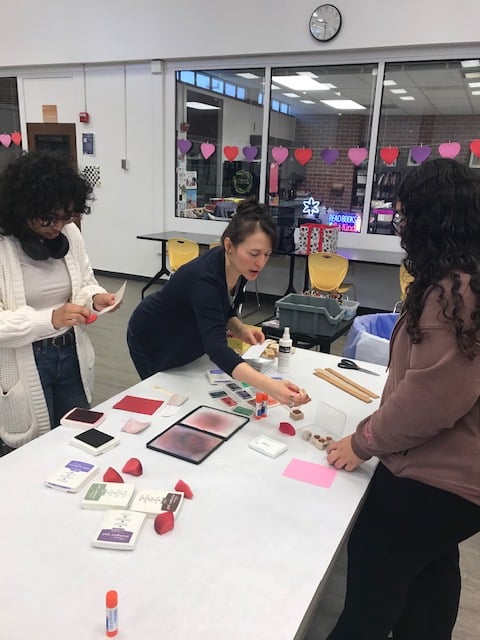 Participants engaging in a creative crafting workshop, working on various crafting projects at a table.