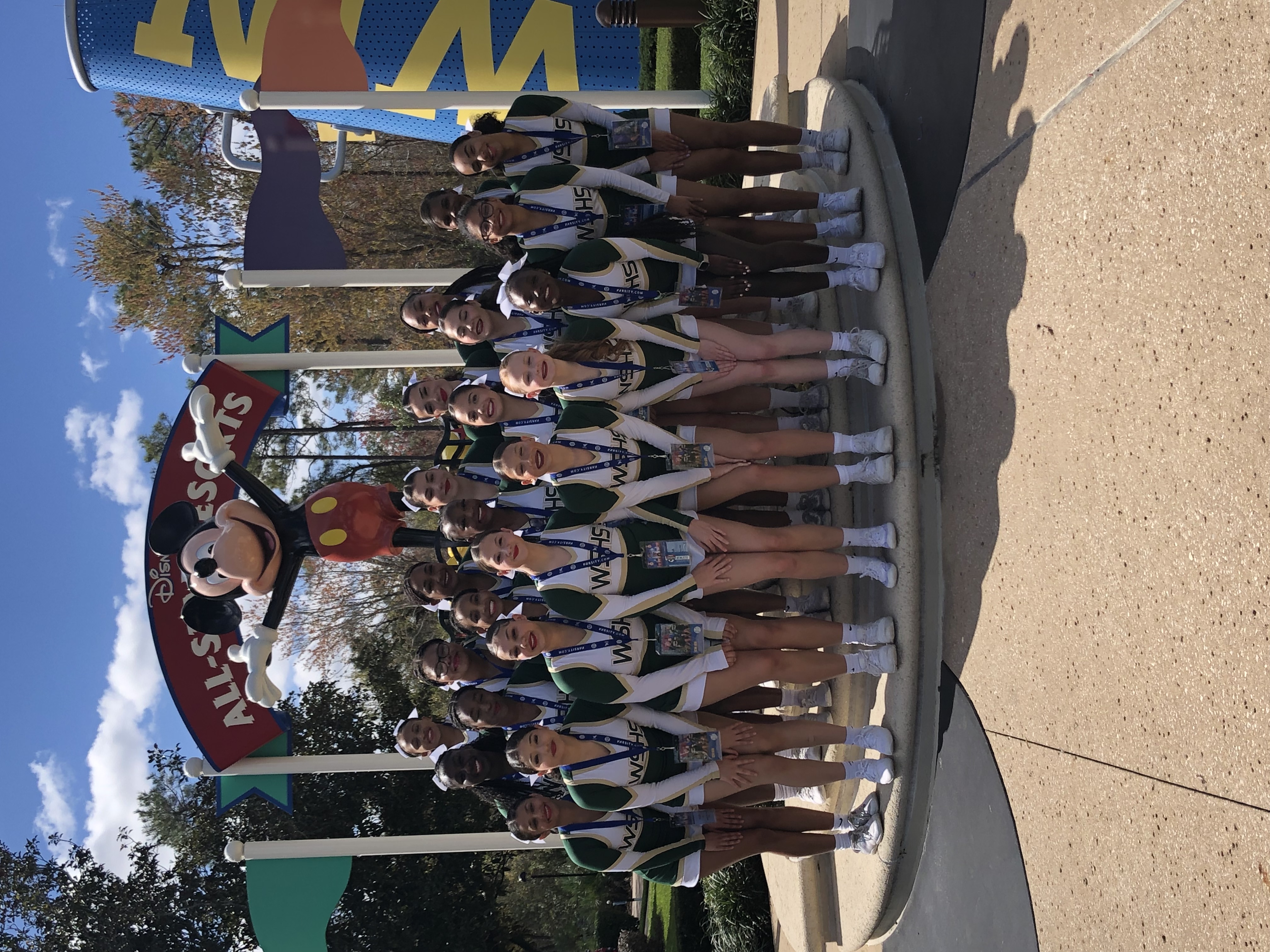 Cheerleading team in front of mickey mouse statue at nationals