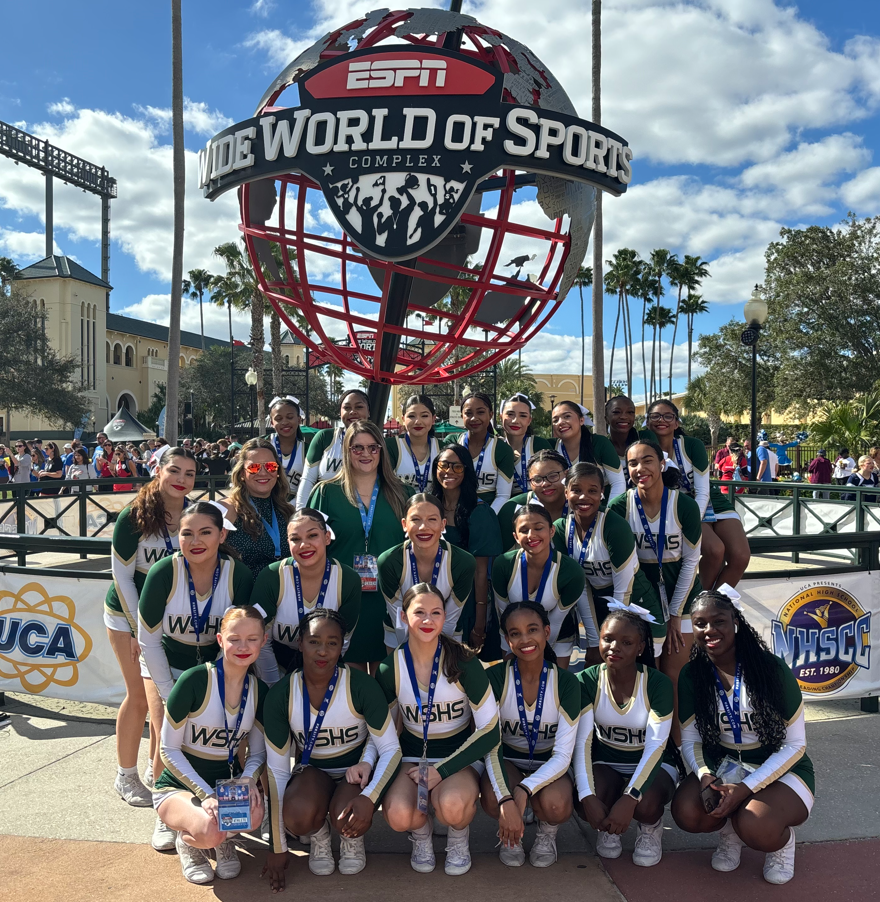 Cheerleading team in front of ESPC wide world of sports statue at nationals