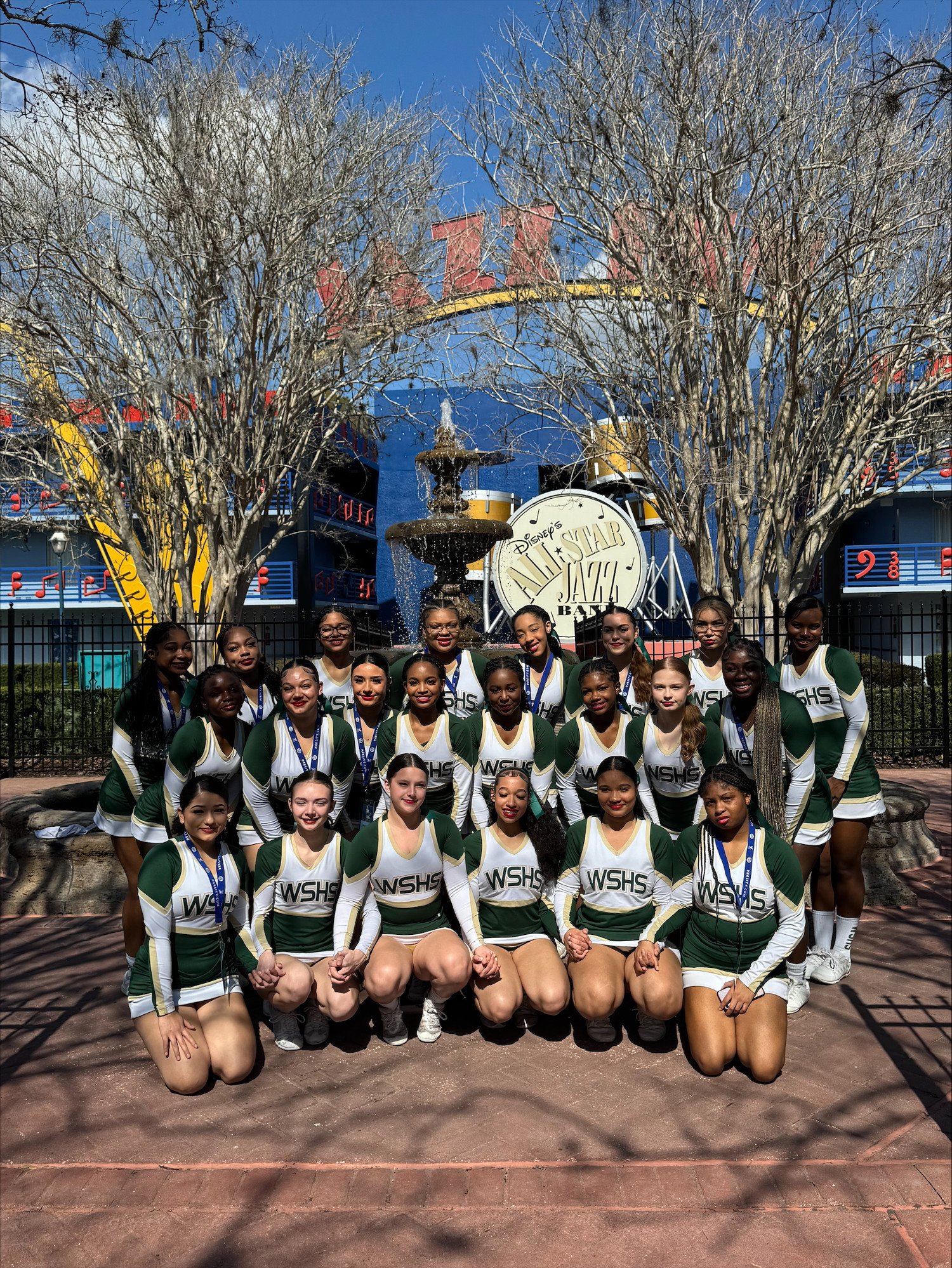 WSHS Cheerleaders posing in front of Disney's All Star Jazz Resort Sign.