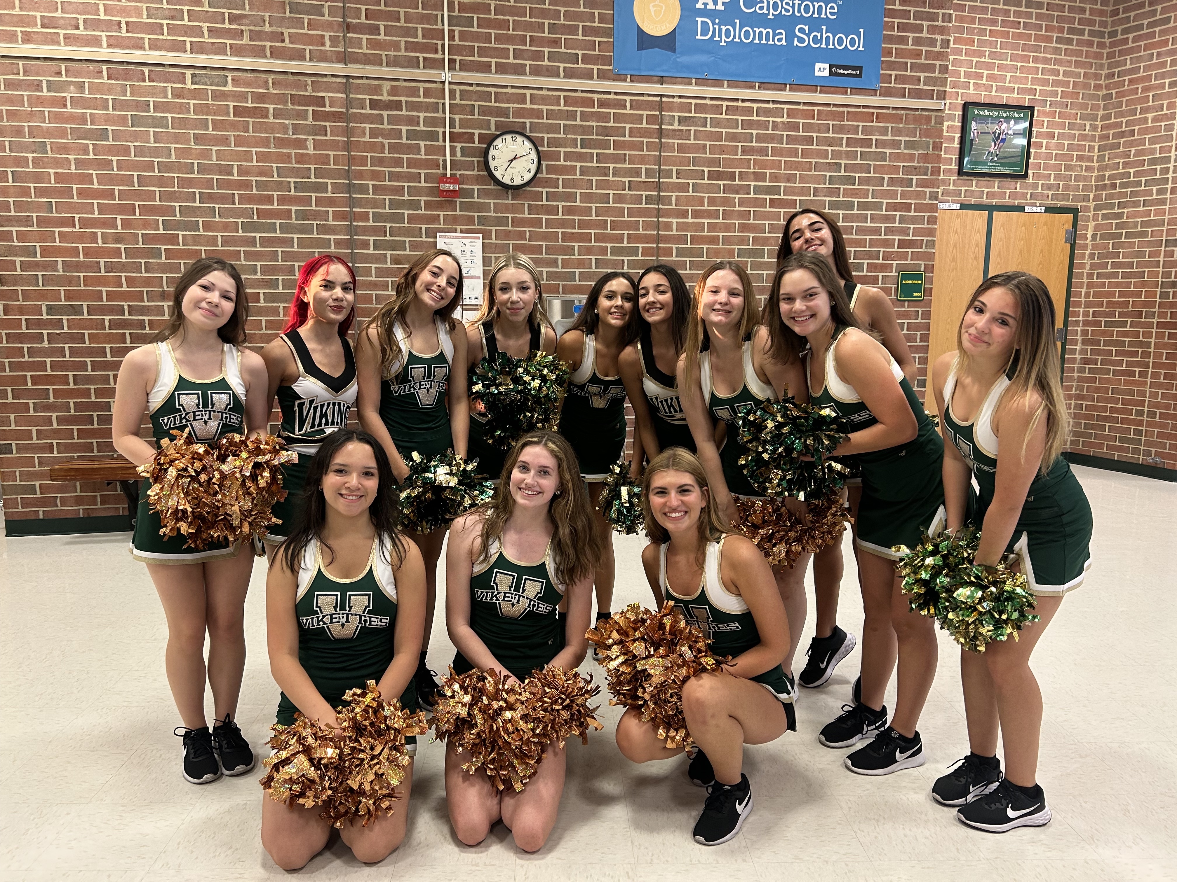 The 2023 to 2024 Vikettes dance team posing in the front lobby at Woodbridge Senior High School